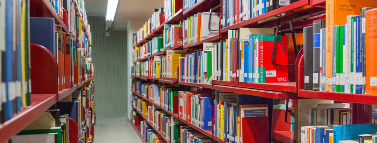 Bibliothek Rote Bücherregale in der Universitätsbilbliothek.