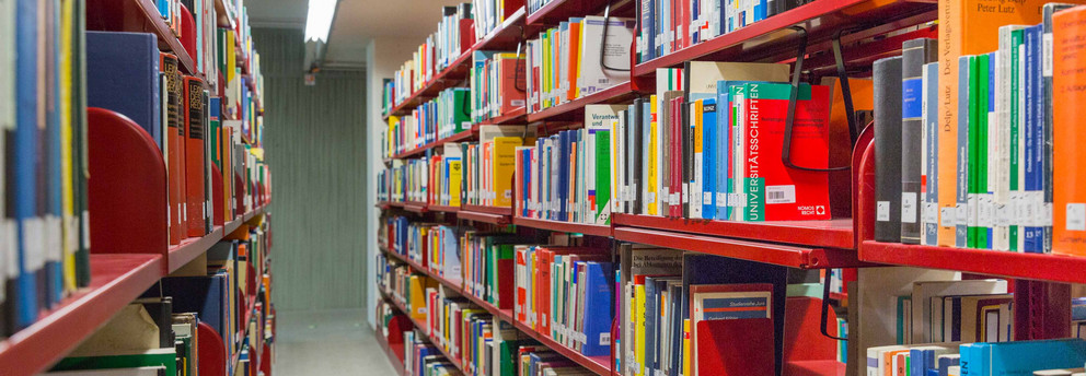 Red bookshelves in the university library.